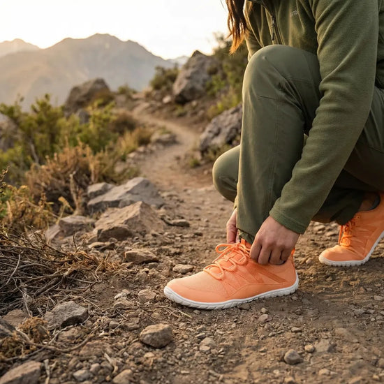 Foto dinámica de persona sentada con zapatillas naranjas.