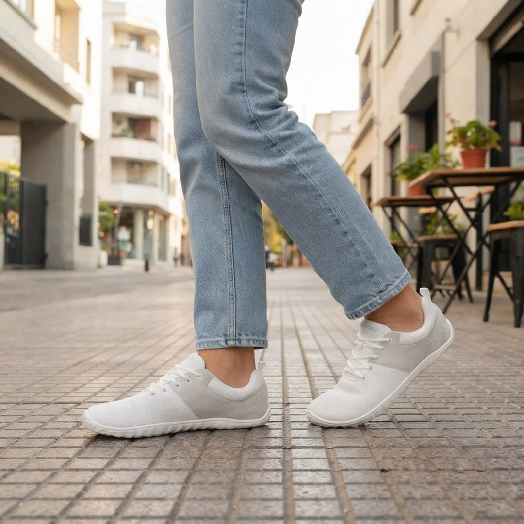 Persona usando Saguaro Wish I blancas caminando con pisada natural barefoot.